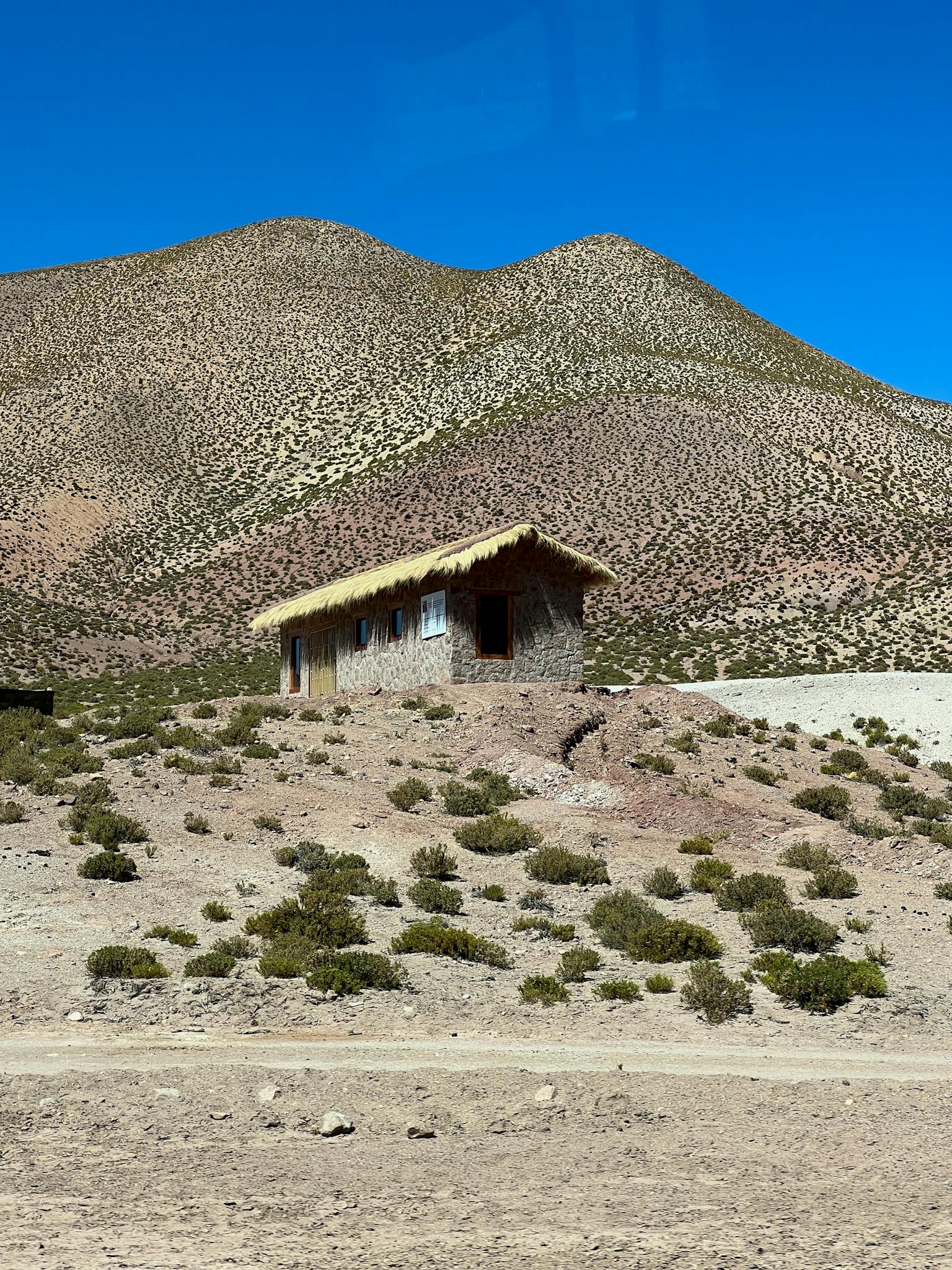 Captivating rural scene of a stone hut amidst the arid beauty of San Pedro de Atacama.
